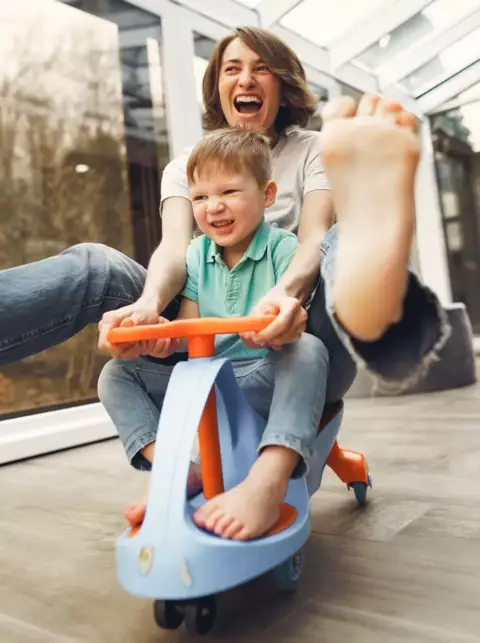 Mom and son playing in their home barefoot