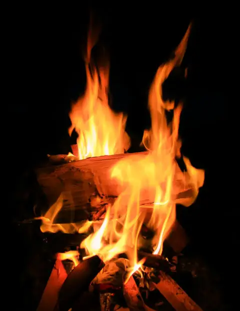 A fire blazing to keep warm.