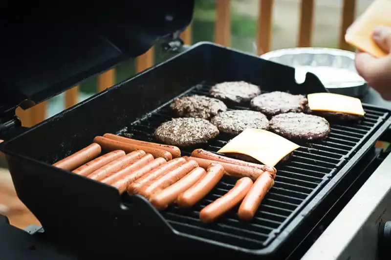 Grilling burgers and hot dogs at a summer barbecue