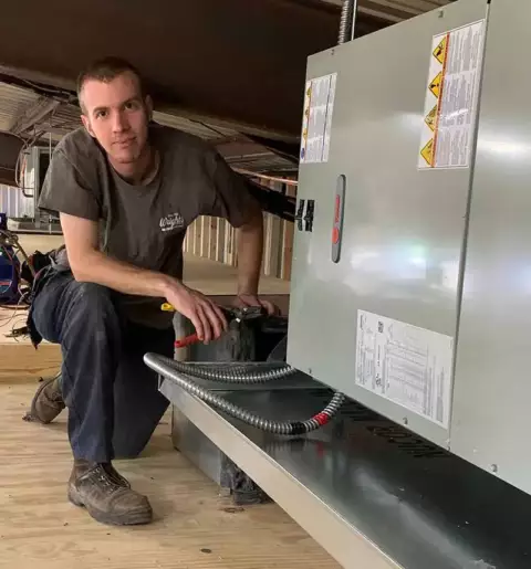 A Wright's Air technicican prepares to do a routine maintenance on a customer's system.