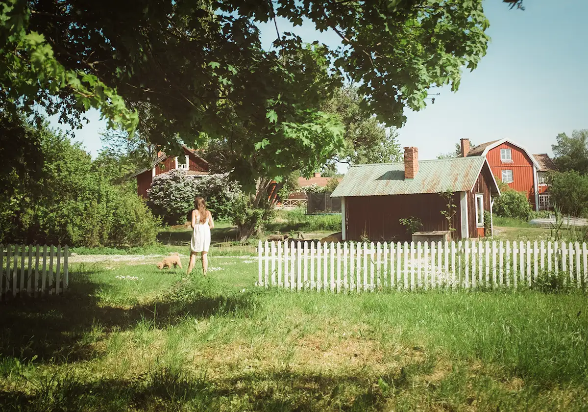 A young girl walking the dog outside on the family farm in Texas.